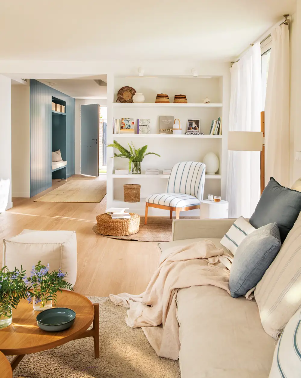 Warm open living room with bookcase and desk